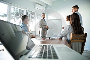 Business man making a presentation at office. Business executive delivering a presentation to his colleagues