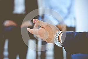 Business man making presentation to group of people, close-up. Speaker delivering a seminar to his colleagues or