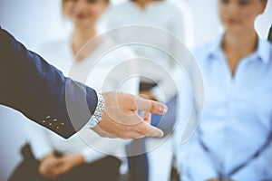 Business man making presentation to group of people, close-up. Speaker delivering a seminar to his colleagues or