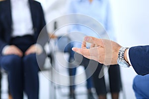 Business man making presentation to group of people. Speaker delivering a seminar to his colleagues or business training