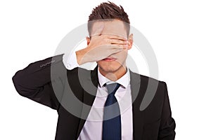 Business man making the see no evil gesture