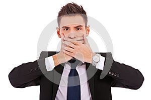 Business man making the speak no evil gesture