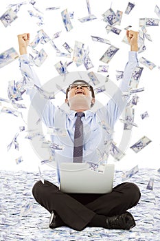 Business man making a successful pose with money rain background