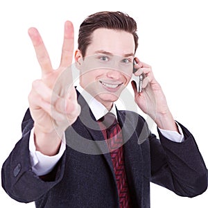 Business man making victory sign on phone