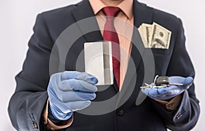 Business man in medical gloves holding credit card and car key, with money in poket, epidemic covi19 photo