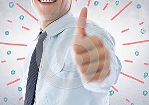 Business man mid section giving thumbs up against white wall with red blue fireworks doodle