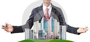 Business man and modern building on green grass field use for land management theme