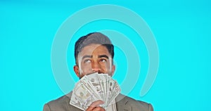 Business man, money fan and winner in studio isolated on a blue background mockup. Cash, winning and rich Indian person