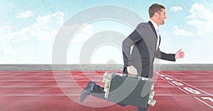 Business man with money sticking out of briefcase on track against sky