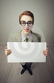 Business man nerd holds a blank sign