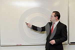 Business man next to a white board