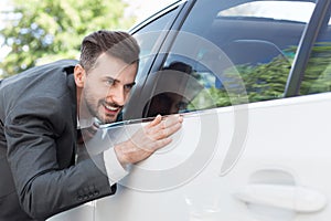 Business man obsessing about cleanliness of car
