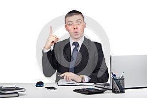 Business man at office holding finger up: idea or warning isolated on white background