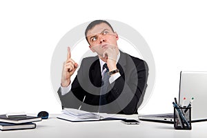 Business man at office holding finger up: idea or warning isolated on white background