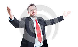 Business man with open arms looking into the camera