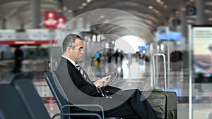 Business man passenger using tablet computer at the airport