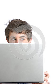 A business man peeking over a modern laptop