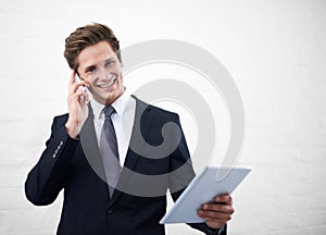 Business man, phone call and tablet by wall, portrait and contact for networking by white background. Entrepreneur