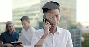 Business man, phone call and talking in city, chatting or networking. Tech, cellphone and Asian man on 5g mobile