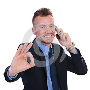 Business man on the phone shows ok