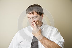 Business man picking his nose