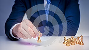 Business man is playing chess, business management strategy concept