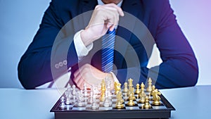 Business man is playing chess, business management strategy concept