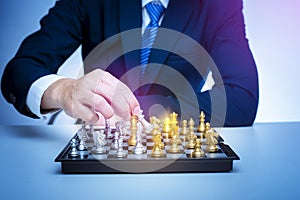 Business man is playing chess, business management strategy concept