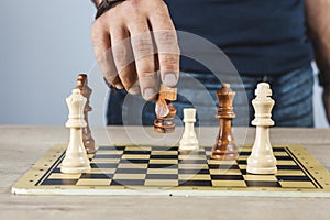 business man playing chess on dark studio background.