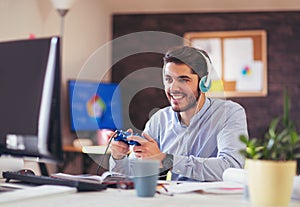 Business man playing videogames in his office photo