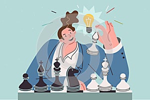 Business man plays chess, coming up with new idea, sitting with light bulb above head
