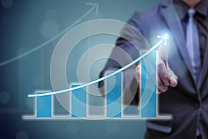 Business man point hand on the top of arrow graph with high rate of growth. The success and growing growth graph in the company or