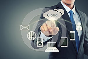 Business man pointing at cloud computing