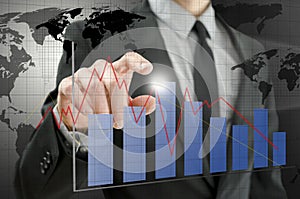 Business man pointing at interactive business graph
