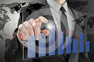 Business man pointing at interactive business graph photo