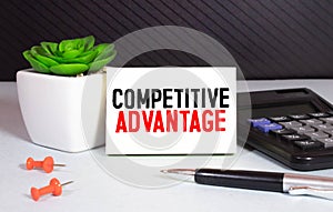Business man pointing to transparent board with text: Competitive Advantage
