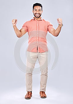 Business man, portrait and excited about winning, champion and success, cheers on studio background. Yes, fist pump and