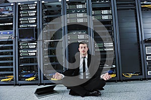 Business man practice yoga at network server room photo