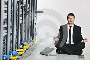 Business man practice yoga at network server room photo