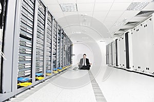 Business man practice yoga at network server room