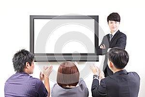 Business man presentation to colleagues with TV