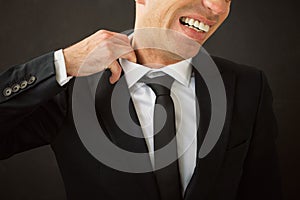 Business man pulling his shirt of his neck