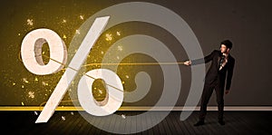 Business man pulling rope with big procent symbol sign