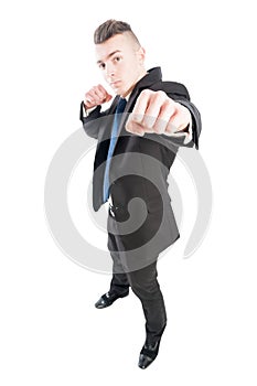 Business man punching the camera with naked fist