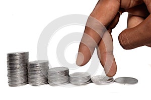 Business man putting fingers on coin and looking for profit growth up, Collecting money with earning bank deposit interest. Busine