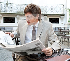 Business man reading paper.