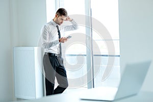 Business Man Reading Something on the Screen of His Cell Phone