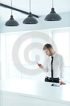 Business Man Reading Something on the Screen of His Cell Phone