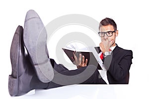 Business man reading a thriller book