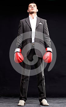 Business man ready to fight with boxing gloves - isolated